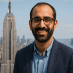 Zohran Mamdani standing in front of the Empire State Building